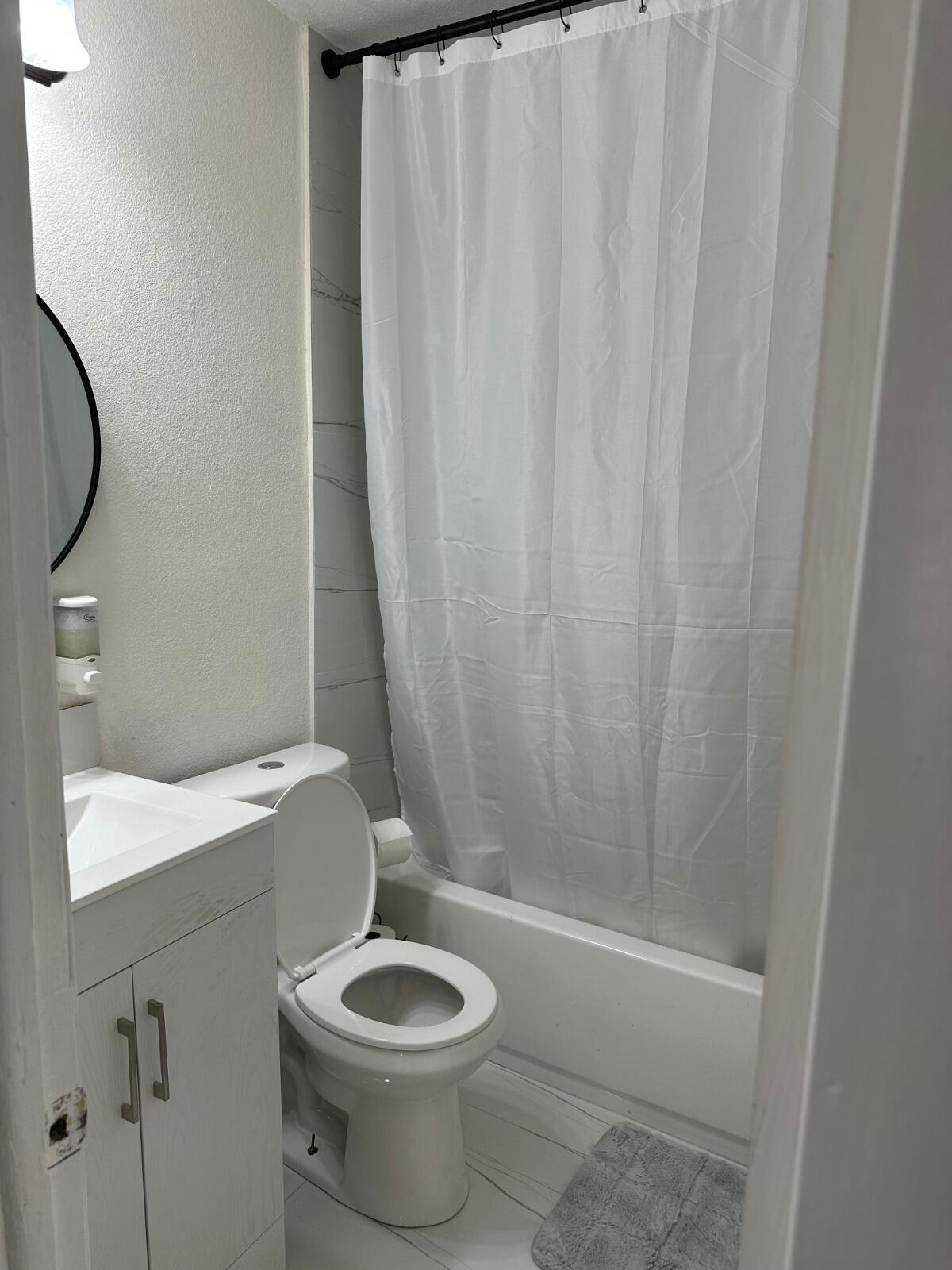 5131 Southwest 6th Court Margate, FL 33068 - Photo 12 of 25 a white toilet sitting next to a shower