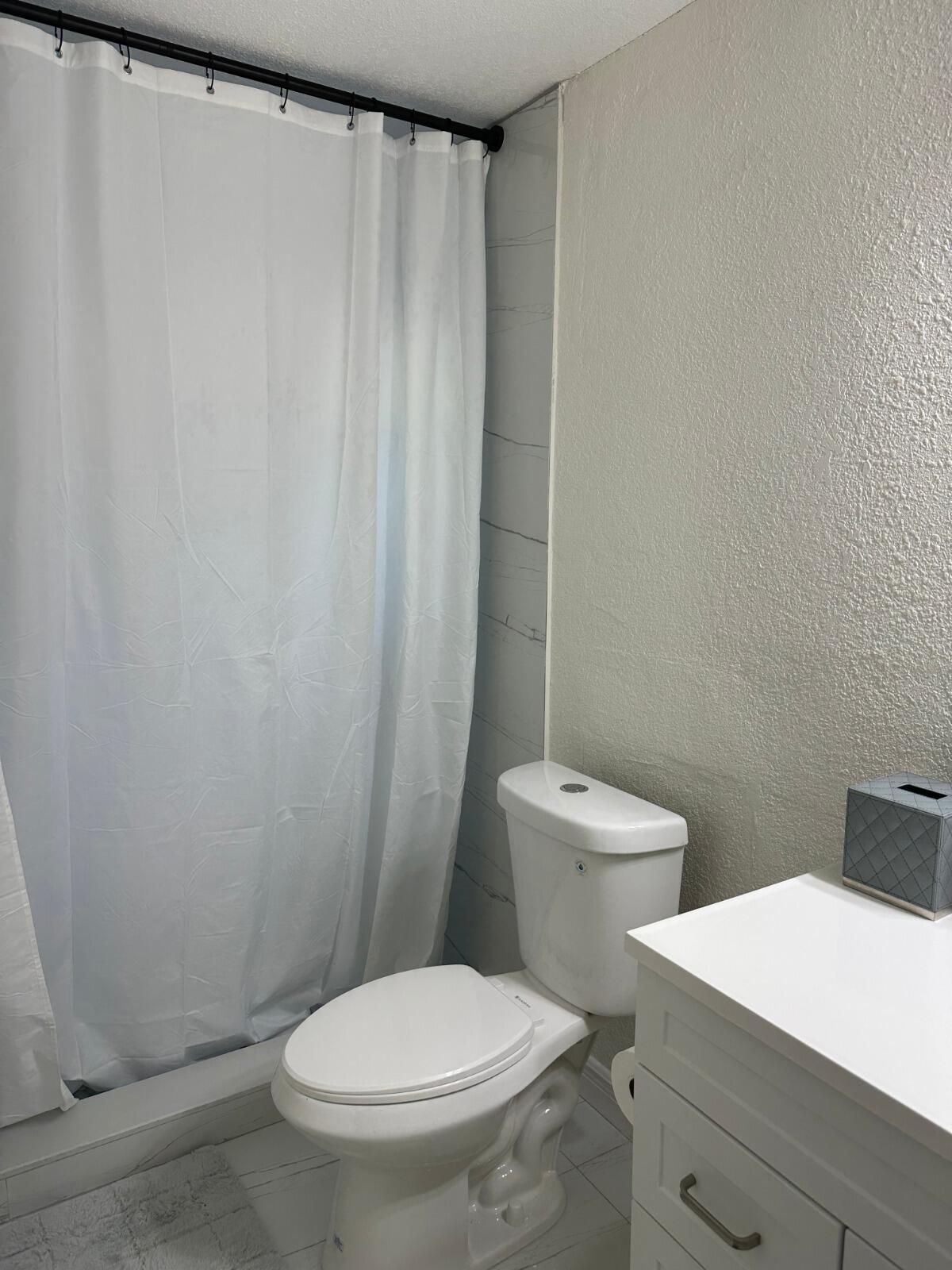 5131 Southwest 6th Court Margate, FL 33068 - Photo 16 of 25 a white toilet sitting next to a bathroom sink