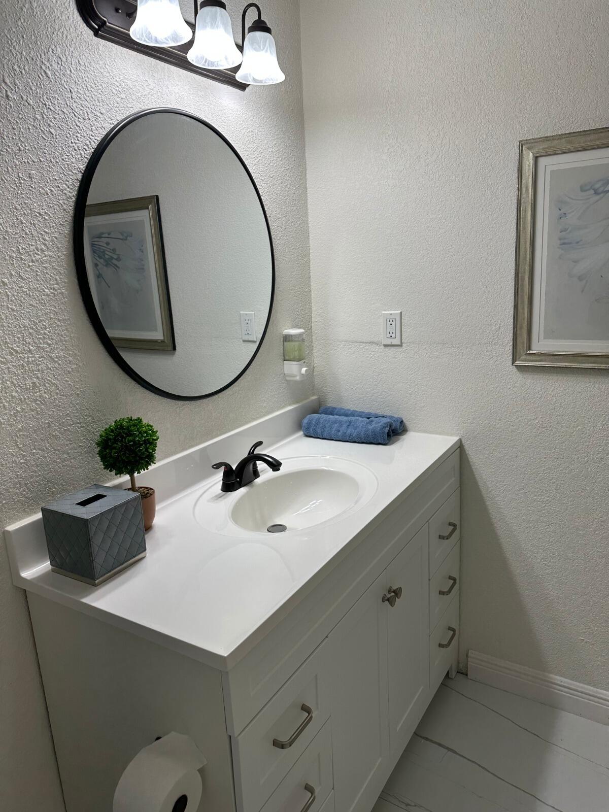 5131 Southwest 6th Court Margate, FL 33068 - Photo 10 of 25 a bathroom with a sink and a mirror