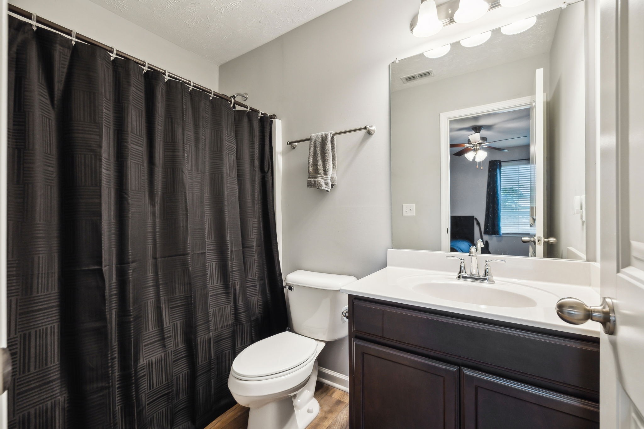 2336 Convention Way Murfreesboro, TN 37130 - Photo 20 of 23 a bathroom with a sink a toilet a mirror and shower curtain