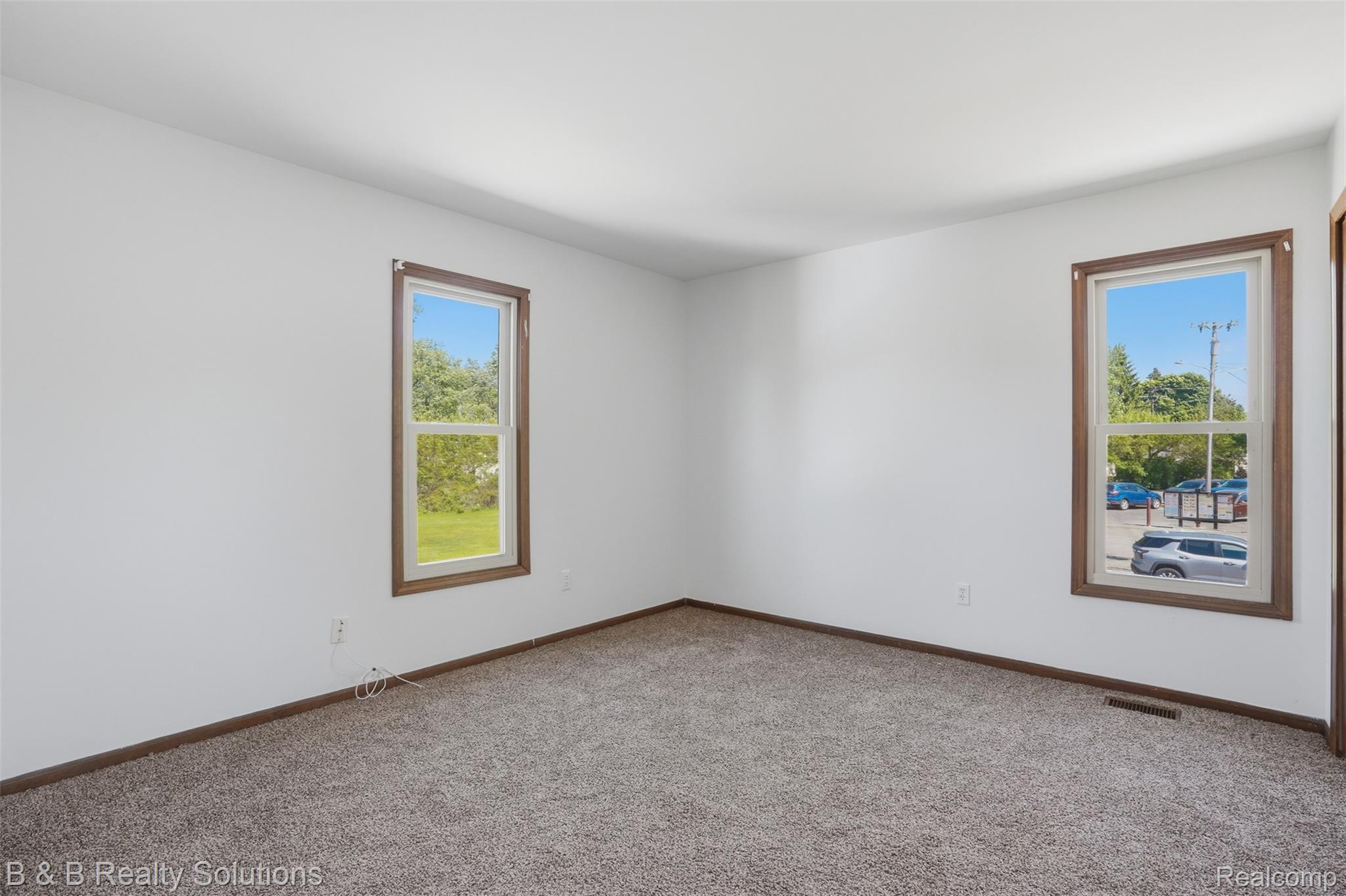 780 North Van Dyke Road, Unit APARTMENT #1 Almont, MI 48003 - Photo 24 of 28 Spacious room featuring neutral carpet flooring and white painted walls
