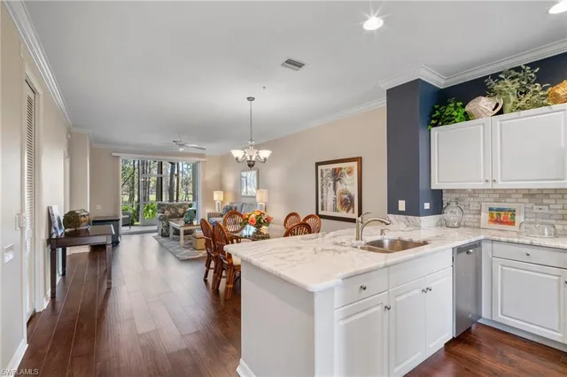 a view of a kitchen area with furniture and wooden floor