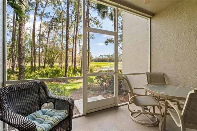 a balcony with chairs and a table