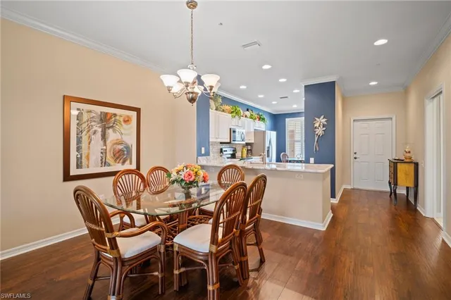 a view of a dining room with furniture wooden floor and chandelier