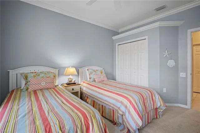 a bedroom with two beds and a lamp