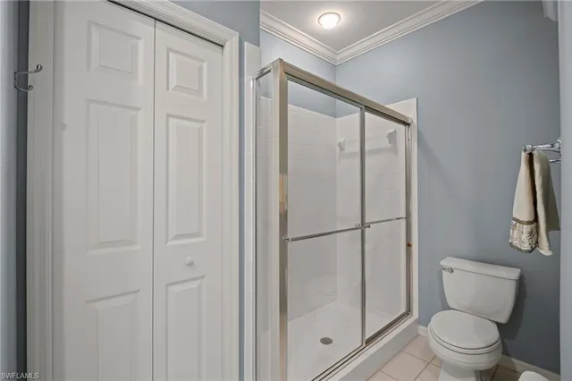 a bathroom with a shower a toilet and a sink