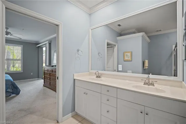 a en suite bathroom with a double vanity sink and a mirror