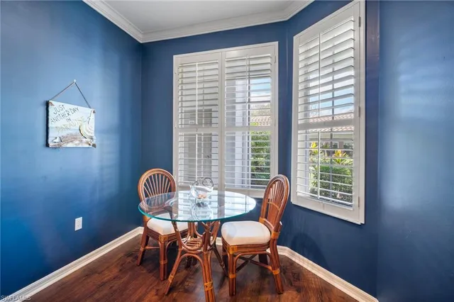 a dining room with furniture and wooden floor
