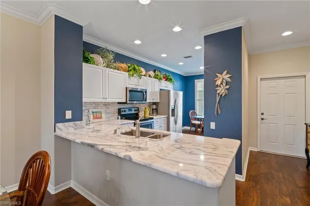 a large kitchen with kitchen island granite countertop a large counter top appliances and cabinets