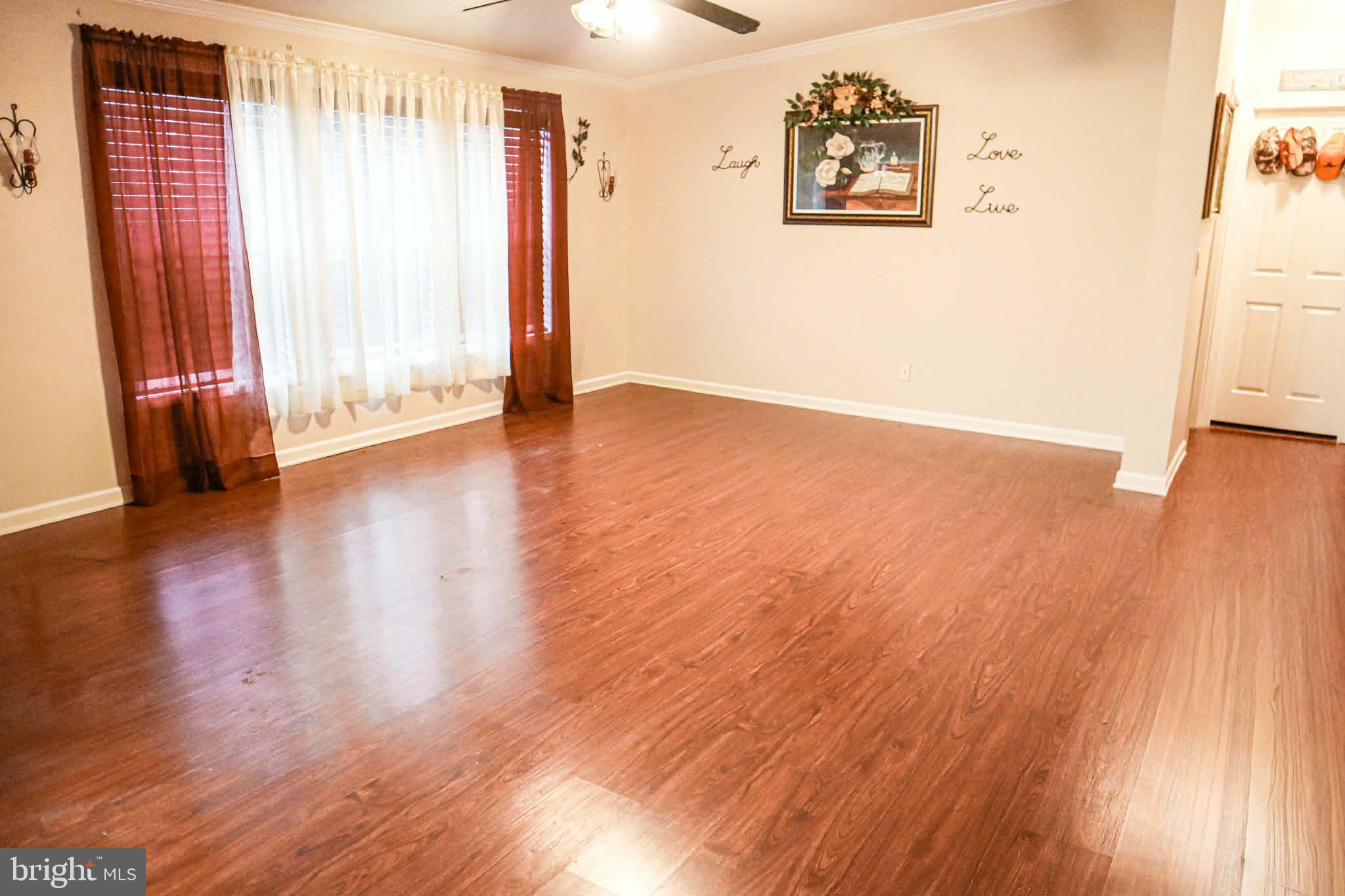 39 Queen Eleanor Drive Elkton, MD 21921 - Photo 6 of 11 an empty room with wooden floor and windows