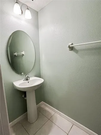 a bathroom with a sink toilet and mirror