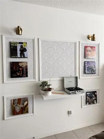 a kitchen with white cabinets and black appliances