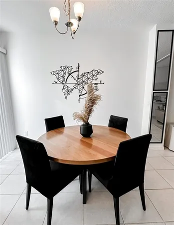 a view of a dining room with a table and chairs