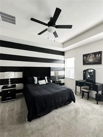 a bedroom with a bed a dresser and a window