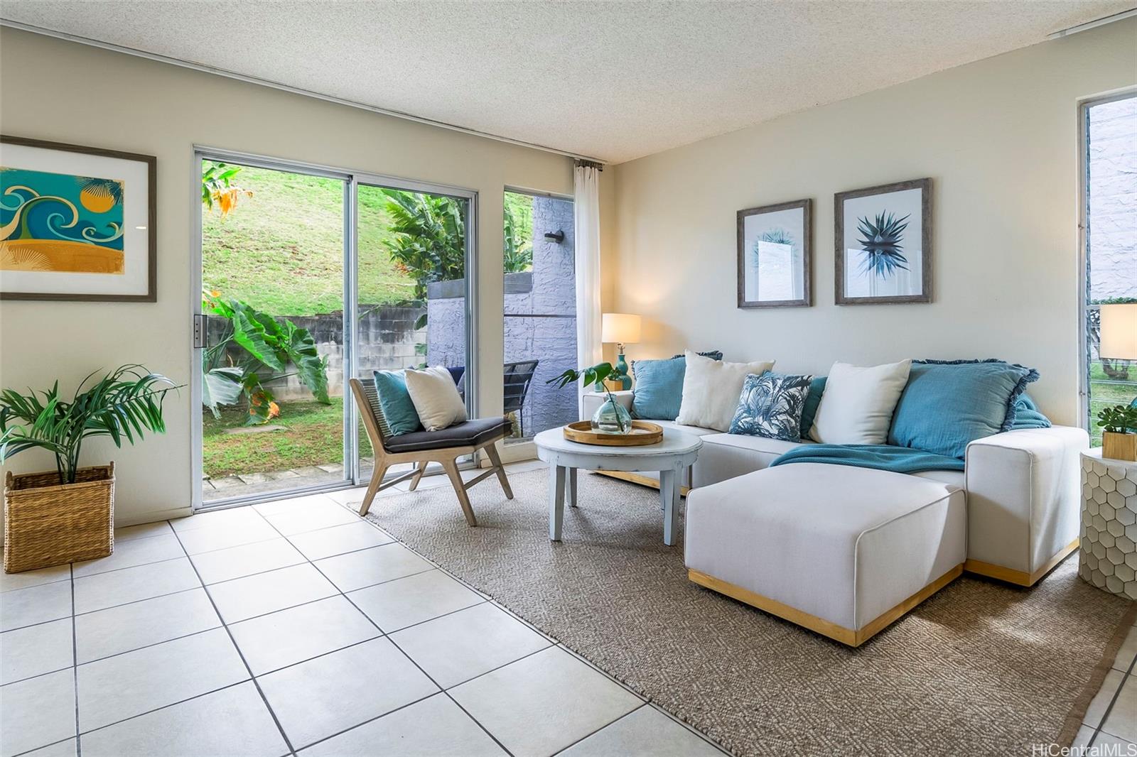 47-257-a Hui Iwa Street, Unit 51 Kaneohe, HI 96744 - Photo 1 of 1 a living room with furniture and a large window