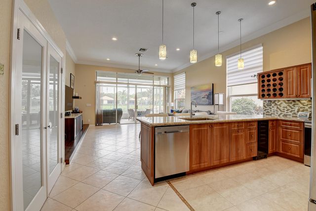 a living room with furniture a flat screen tv and a floor to ceiling window
