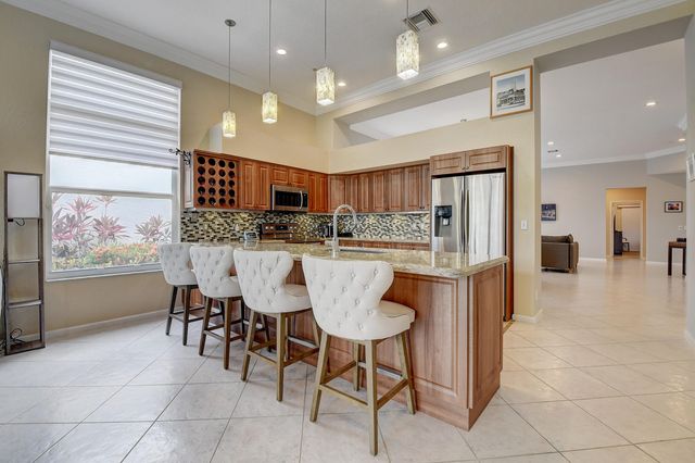 a kitchen with granite countertop a refrigerator stove and microwave