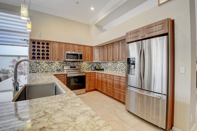 a kitchen with stainless steel appliances granite countertop a sink stove and microwave