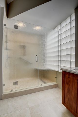 a bathroom with a sink toilet double vanity and tub