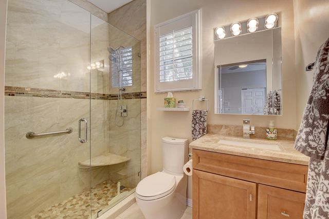 a dining room with furniture and large windows