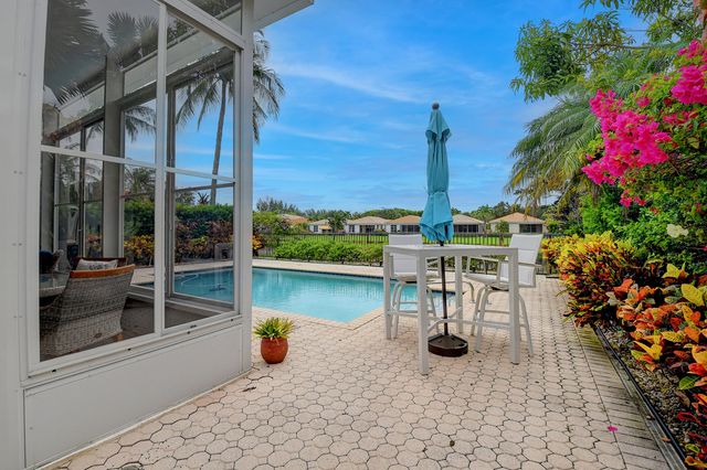 a swimming pool with outdoor seating and yard