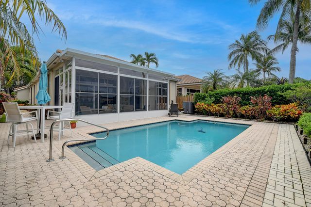 a front view of a house with a garden and trees