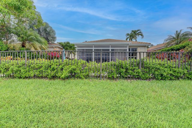 an aerial view of lake residential houses with outdoor space and trees all around