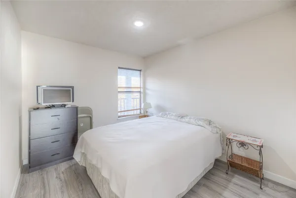 a bedroom with a bed and a lamp