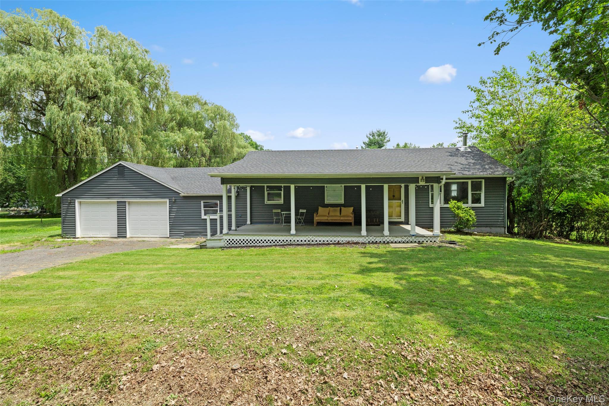 44 Woods Road Tivoli, NY 12583 - Photo 1 of 25 Ranch-style home featuring a porch, a front yard, a garage, driveway, and a shingled roof