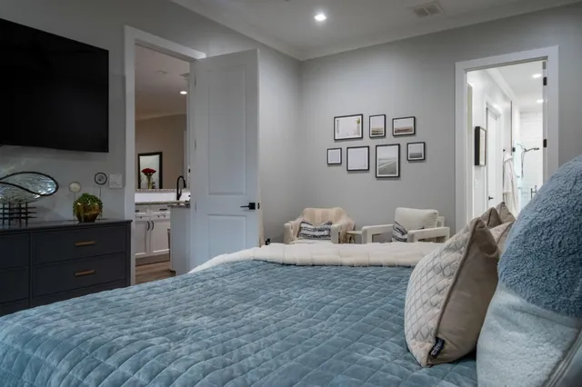 a bedroom with a bed and a flat screen tv