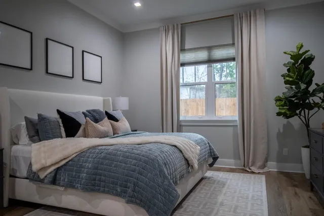 a bedroom with bed and a potted plant