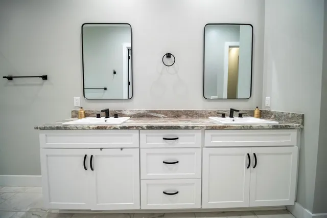 a bathroom with vanity mirror and vanity