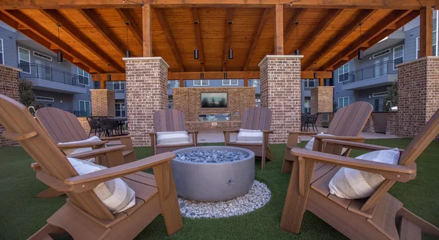 a room with furniture a rug and a fireplace