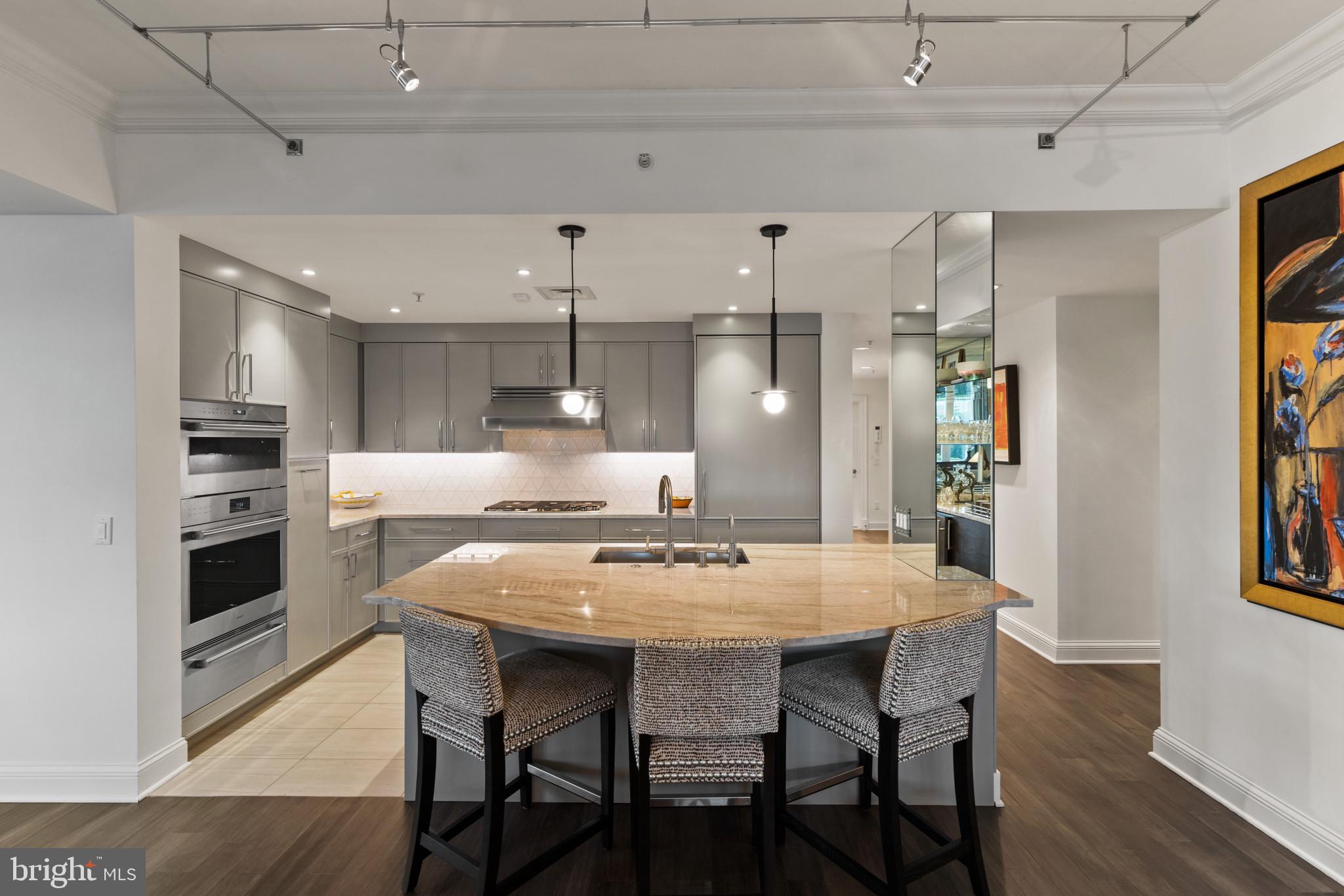 801 Key Highway, Unit 110 Baltimore, MD 21230 - Photo 17 of 78 a kitchen with a dining table and chairs