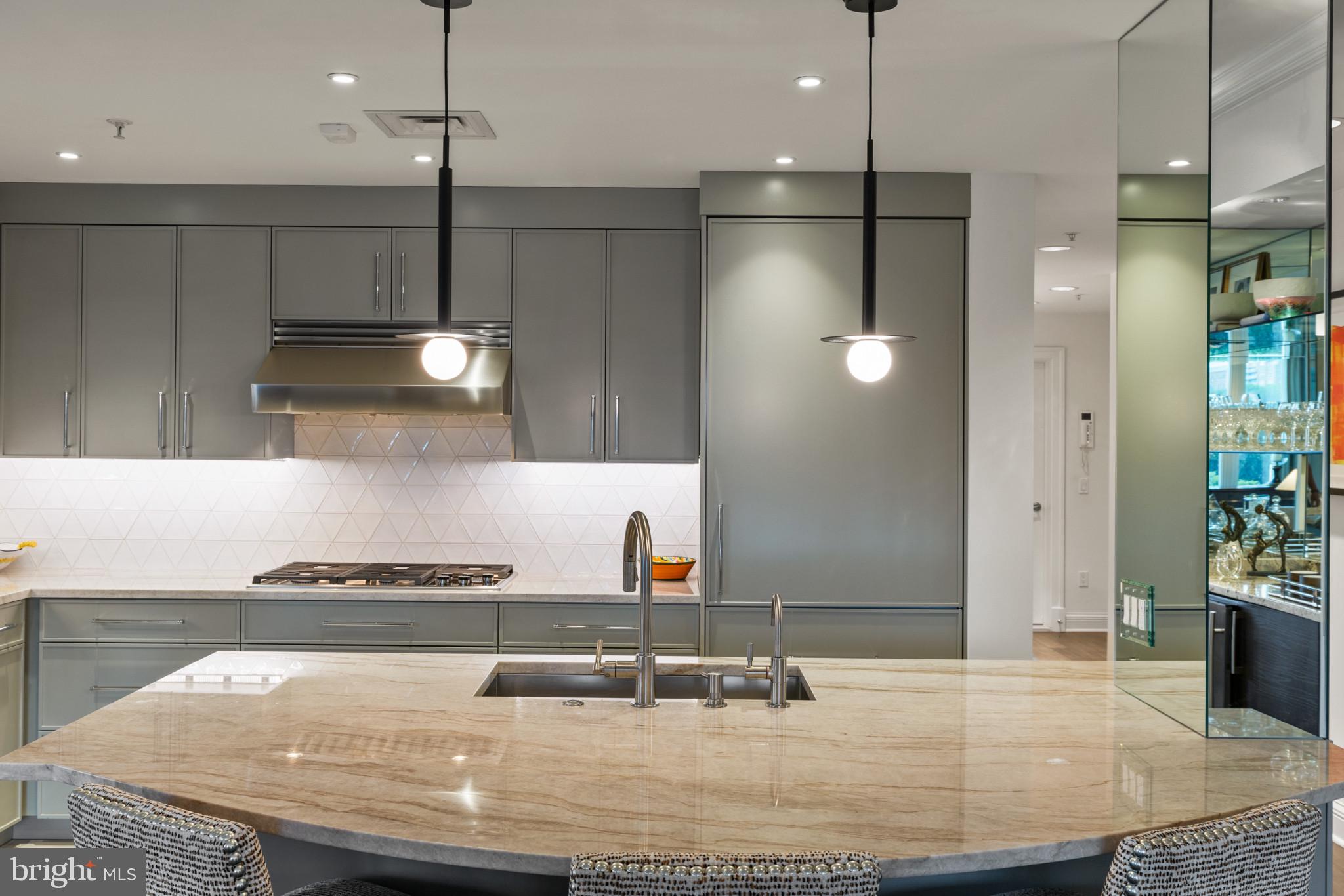 801 Key Highway, Unit 110 Baltimore, MD 21230 - Photo 22 of 78 a kitchen with kitchen island stainless steel appliances a sink stove and refrigerator