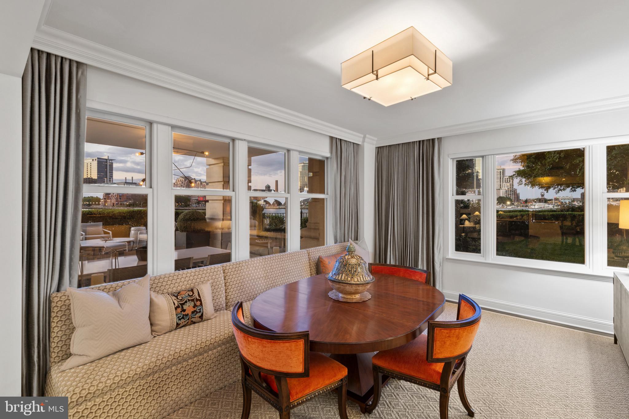 801 Key Highway, Unit 110 Baltimore, MD 21230 - Photo 25 of 78 a view of a dining room with furniture and chandelier