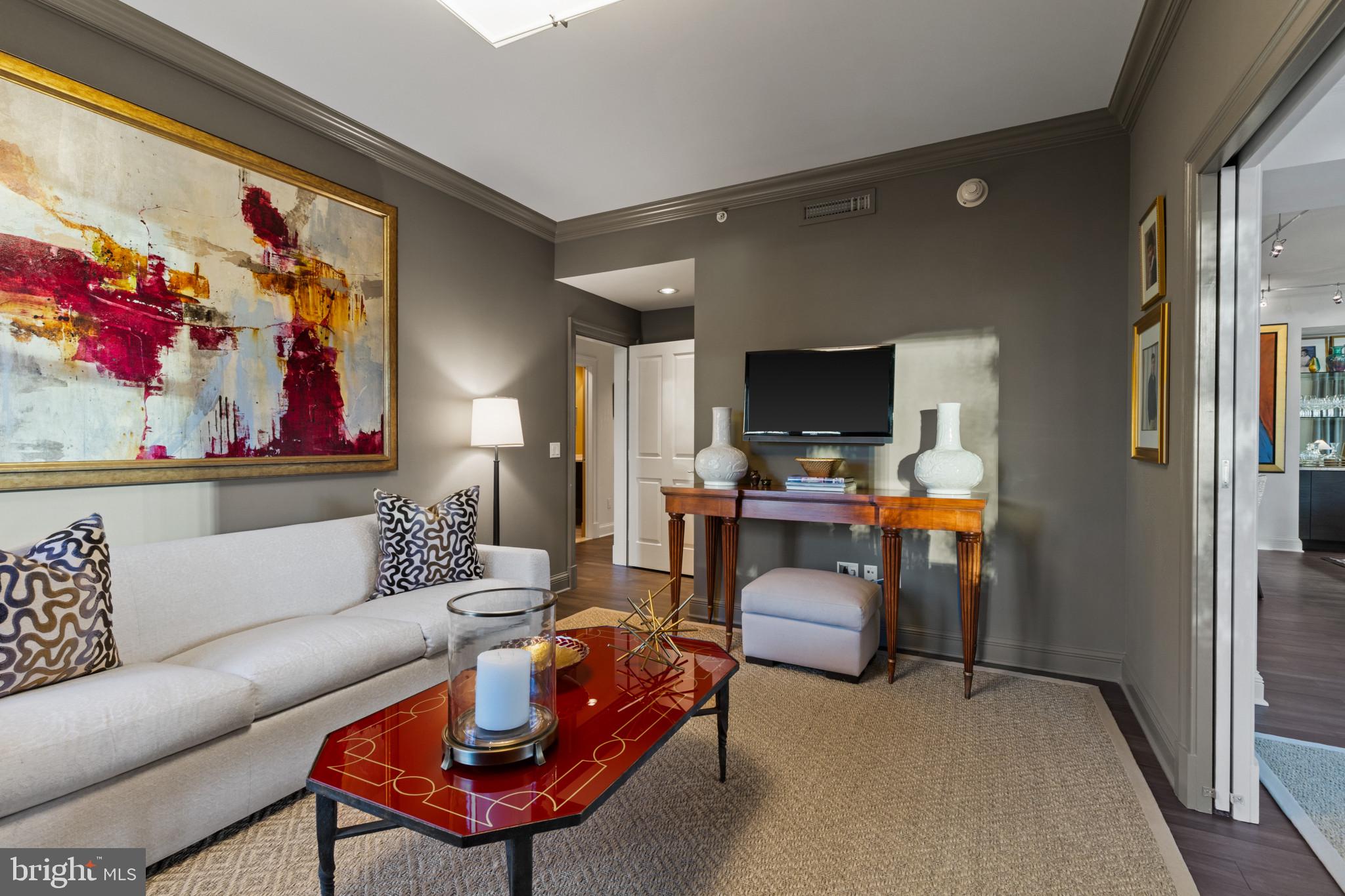 801 Key Highway, Unit 110 Baltimore, MD 21230 - Photo 31 of 78 a living room with furniture and a flat screen tv