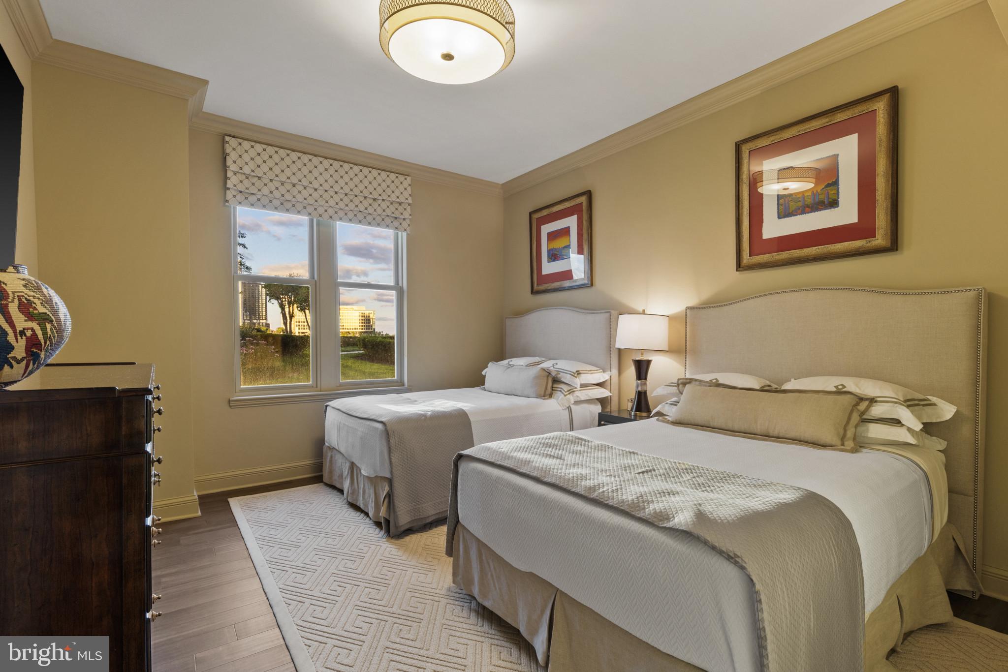 801 Key Highway, Unit 110 Baltimore, MD 21230 - Photo 42 of 78 a bedroom with two beds and a window
