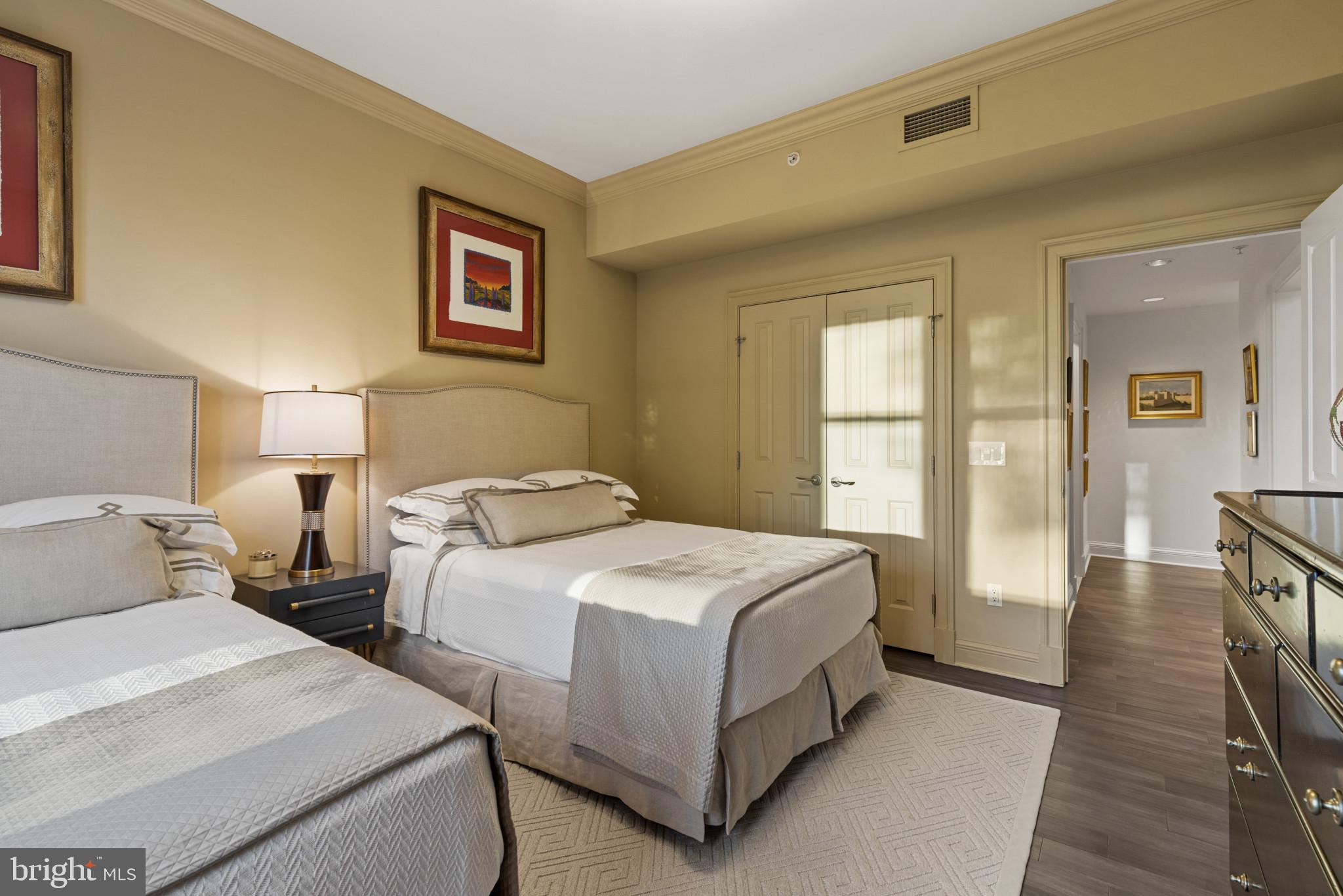801 Key Highway, Unit 110 Baltimore, MD 21230 - Photo 43 of 78 a bedroom with two beds and a large window