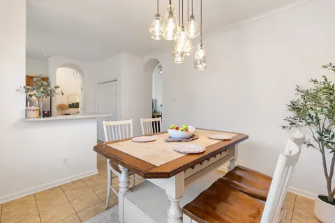 a view of a dining room with furniture and a chandelier