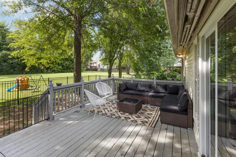 a view of a deck with two chairs and a yard