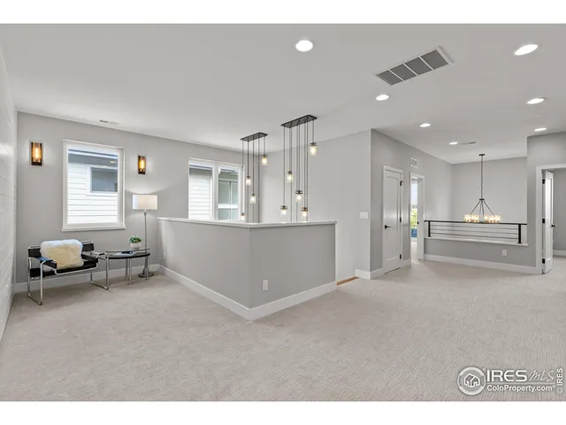 a view of a livingroom with furniture and a ceiling fan