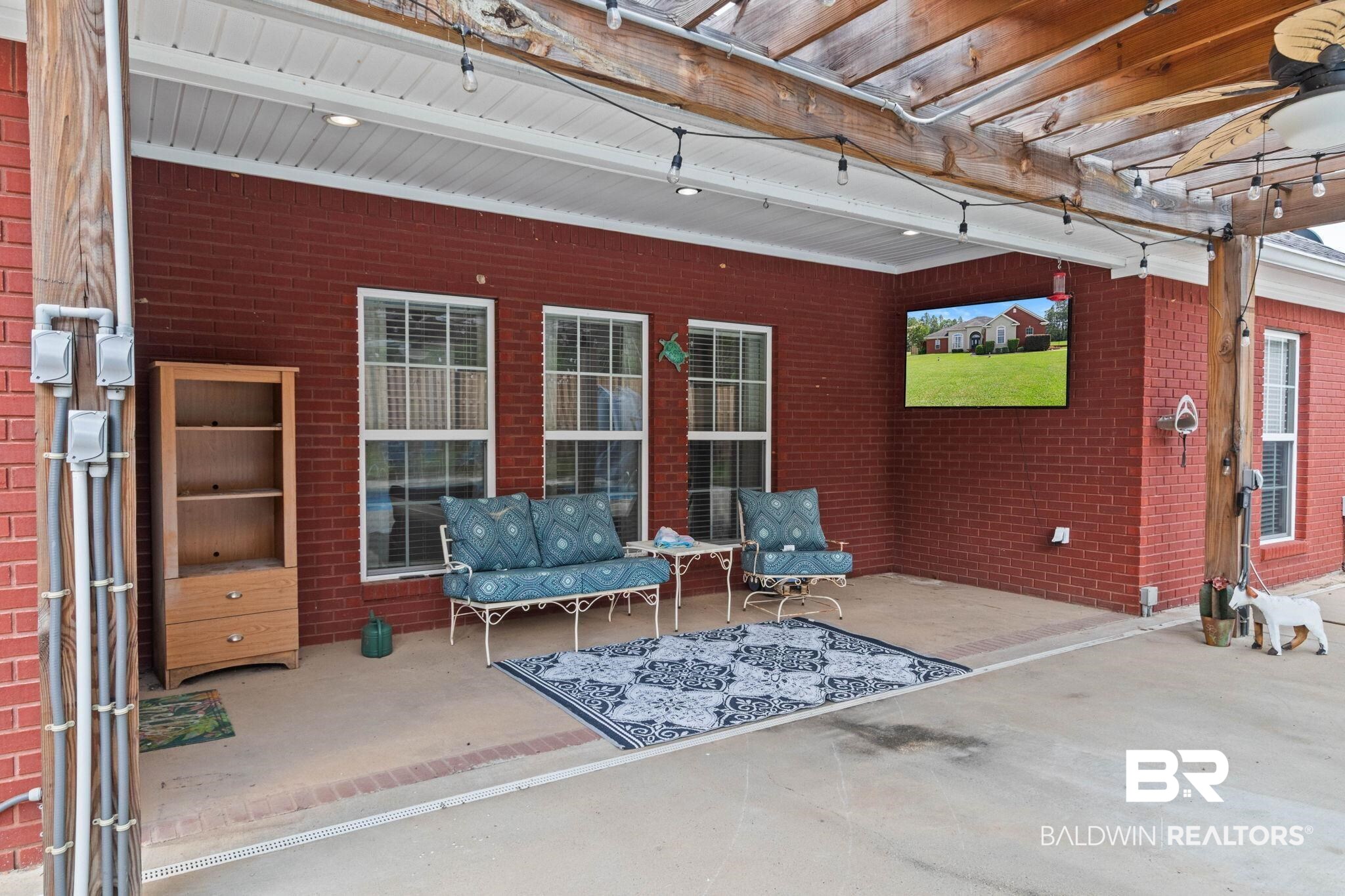 79 Whitetail Run Chatom, AL 36518 - Photo 72 of 82 Covered patio featuring a brick exterior and a wood pergola