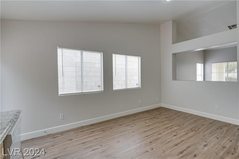 9660 Crystal Ridge Road Las Vegas, NV 89123 - Photo 9 of 18 Laminate flooring extends throughout this naturally illuminated living space, offering a clean, contemporary aesthetic.