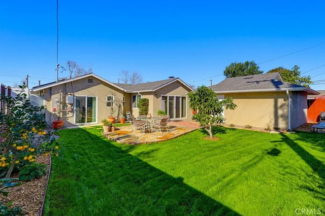 a view of a house with yard and a garden
