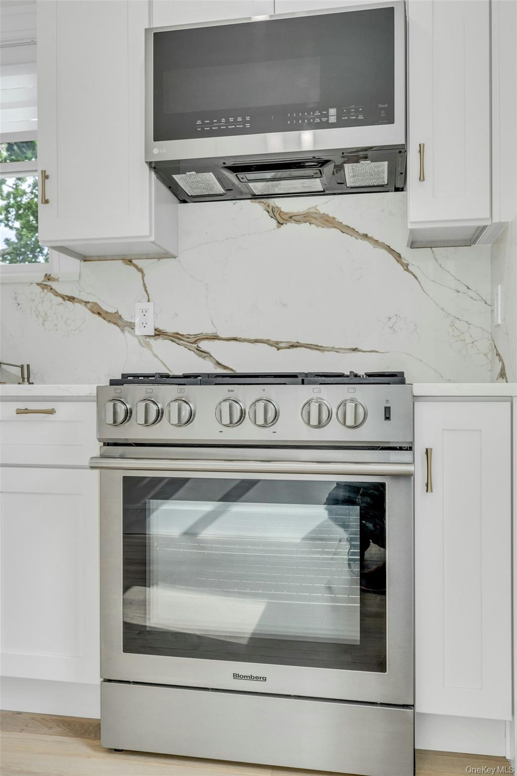 76 Green Street, Unit #2 Huntington, NY 11743 - Photo 12 of 28 a close view of stove with microwave