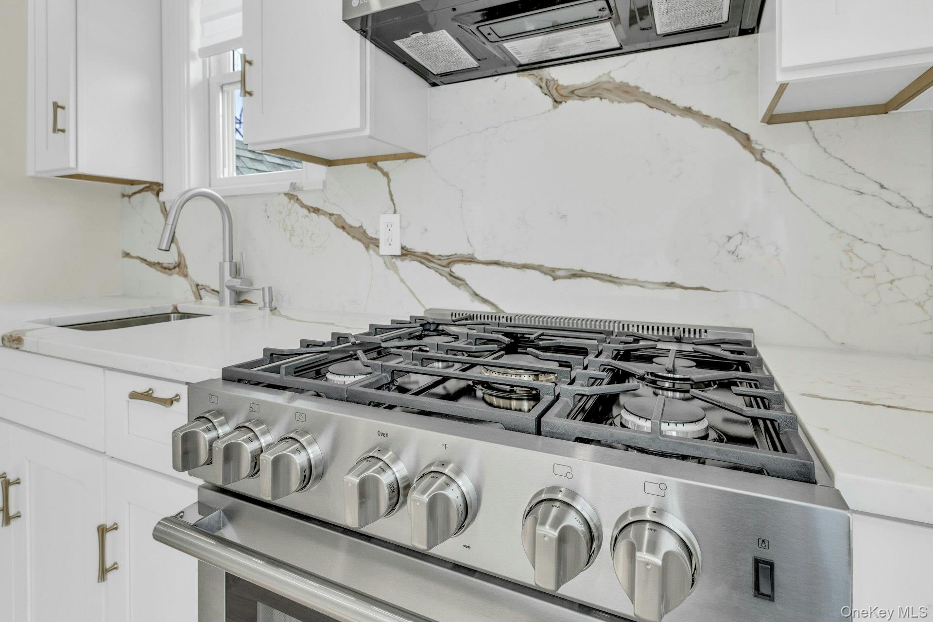 76 Green Street, Unit #2 Huntington, NY 11743 - Photo 13 of 28 a close view of a stove a microwave and a sink in a kitchen