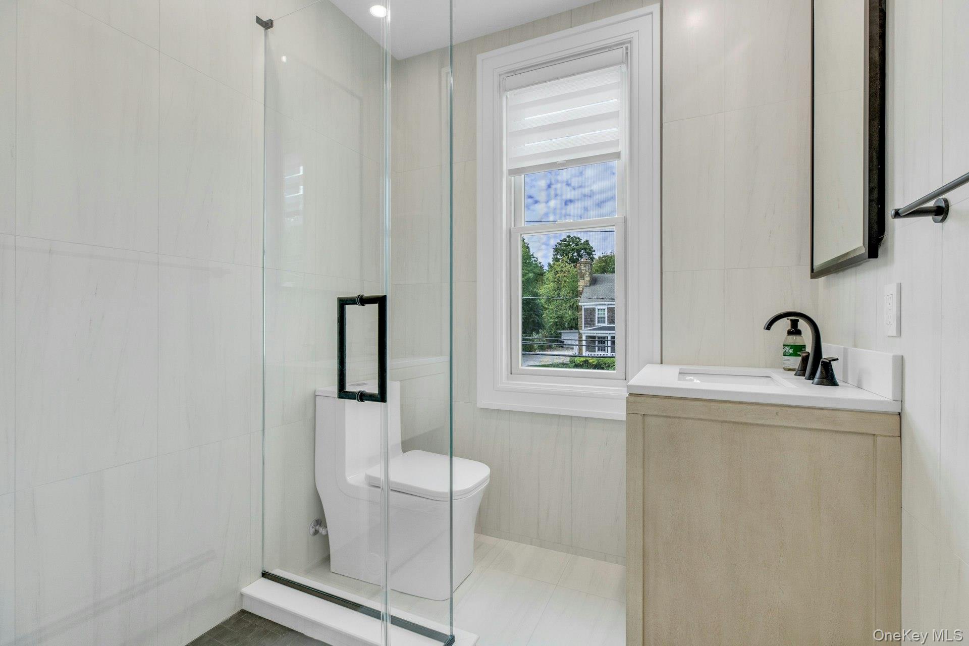 76 Green Street, Unit #2 Huntington, NY 11743 - Photo 16 of 28 a white bath tub sitting next to a window