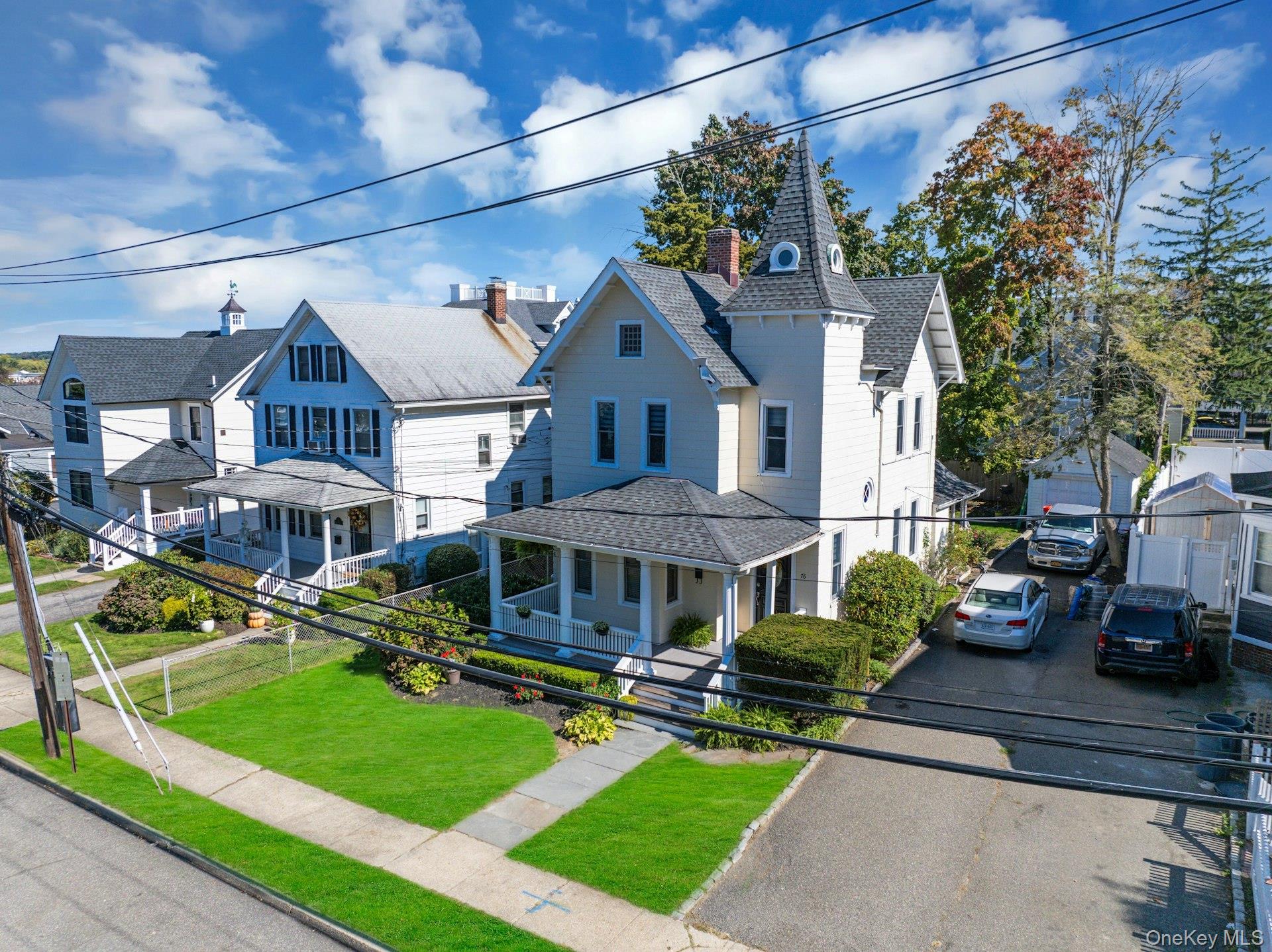 76 Green Street, Unit #2 Huntington, NY 11743 - Photo 27 of 28 a front view of a house with a yard
