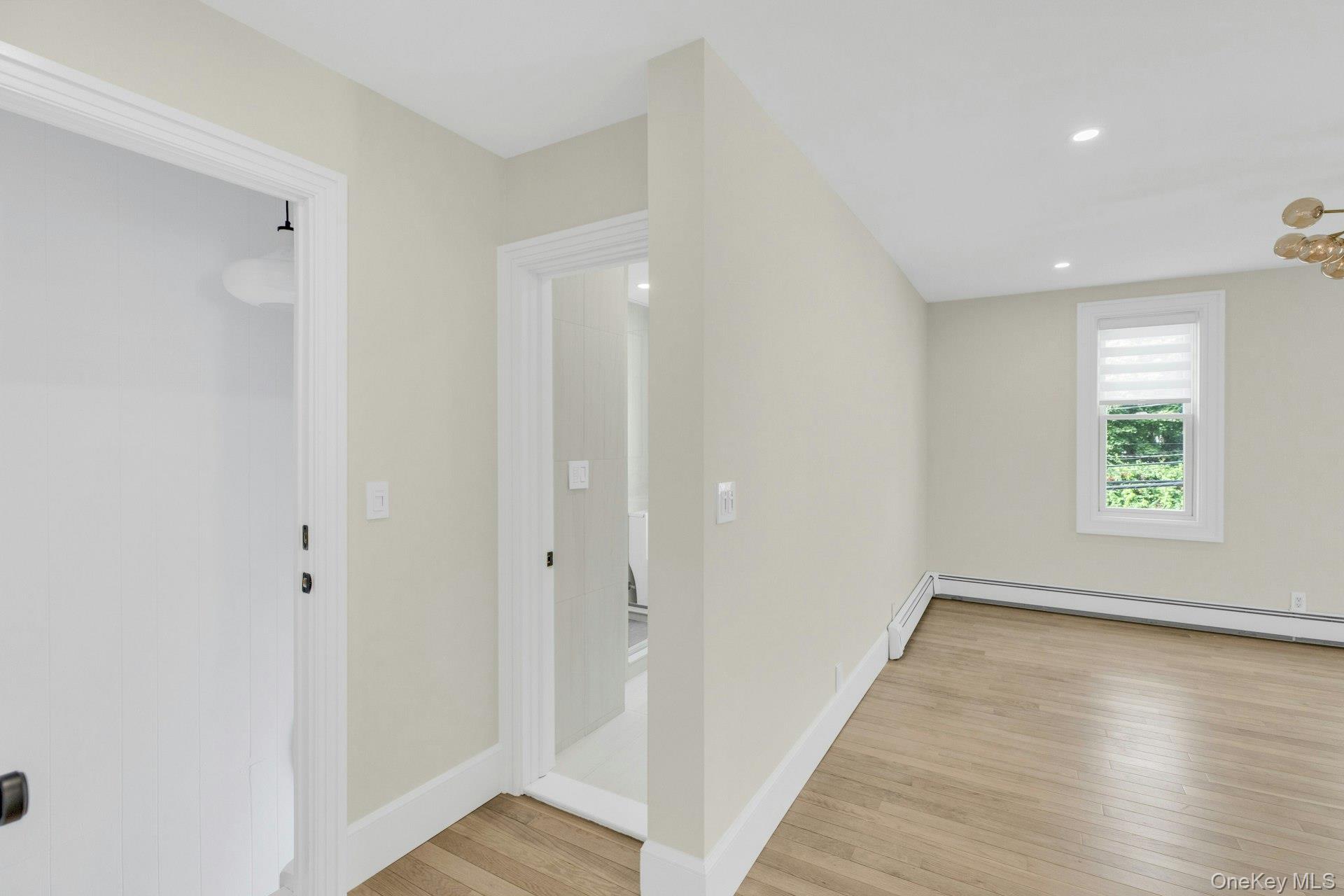 76 Green Street, Unit #2 Huntington, NY 11743 - Photo 6 of 28 wooden floor in an empty room with a window
